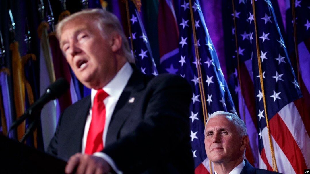 President-elect Donald Trump speaks as Vice president-elect Mike Pence watches during an election night rally in New York, Nov. 9, 2016.
