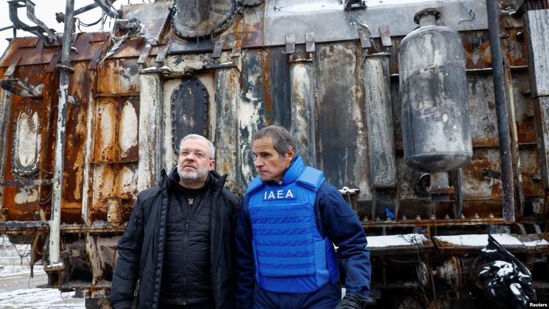 Ukrainian Energy Minister German Galushchenko, left, and International Atomic Energy Agency Director General Rafael Grossi, right, visit an energy infrastructure facility damaged during Russian missile and drone strikes in an undisclosed location in Ukraine, Feb. 4, 2025.