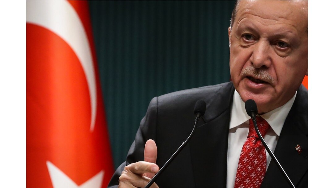 Turkish President Recep Tayyip Erdogan gestures as he delivers a speech following a cabinet meeting, in Ankara, on June 9, 2020.