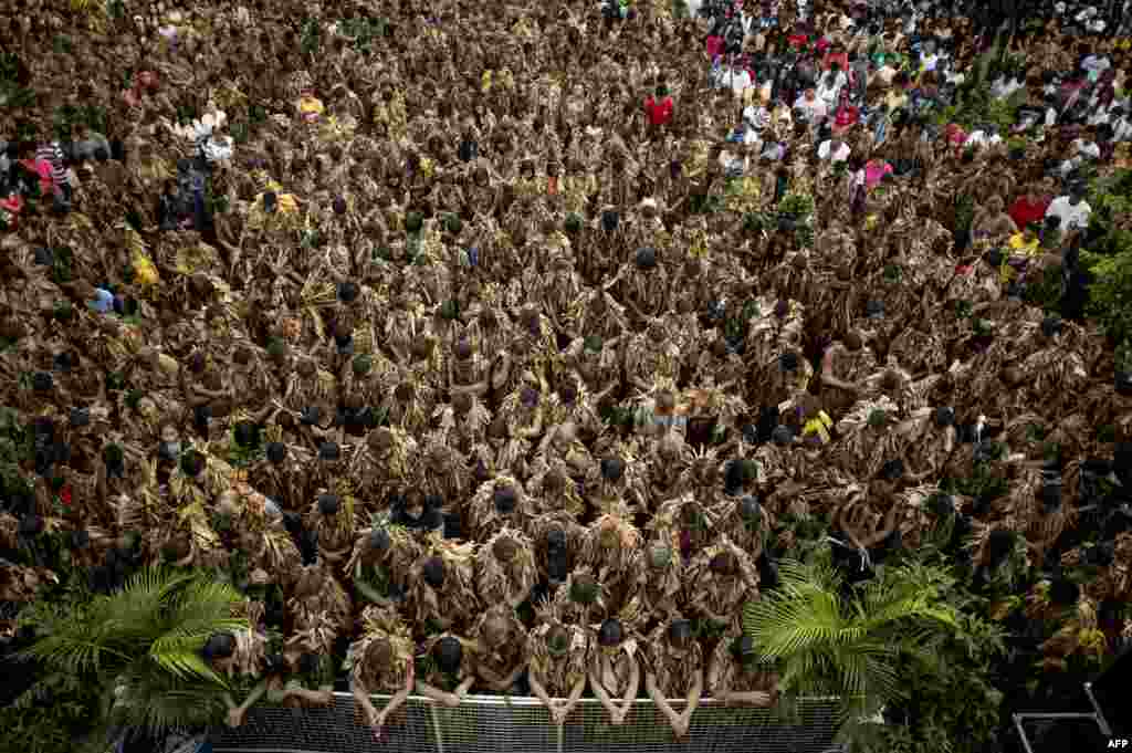 Devotees wearing costumes made of banana leaves attend a Mass as part of a religious festival in honor of St. John the Baptist, also known locally as the "mud people" festival, in Aliaga town, Nueva Ecija province, north of Manila, the Philippines.