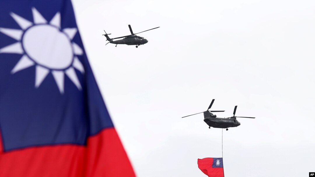Helicopters fly over President Office with Taiwan National flag during the National Day celebrations in Taipei, Taiwan, Oct. 10, 2020. 