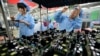 FILE - Employees are seen working on a FiberHome Technologies Group factory production line in Wuhan, Hubei province, China, July 27, 2015.