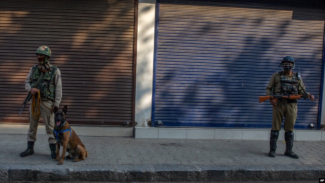 Paramilitary soldiers stand guard on a deserted street on the first anniversary of India’s decision to revoke the disputed region’s semi-autonomy, in Srinagar, Indian controlled Kashmir, Aug. 5, 2020.