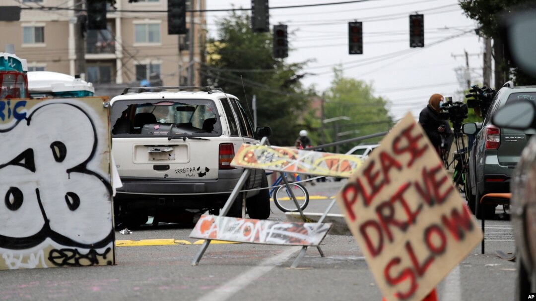 A car with broken windows and bullet holes that was involved in a shooting sits in the street in Seattle, where streets are blocked off in what has been named the Capitol Hill Occupied Protest zone, June 29, 2020.