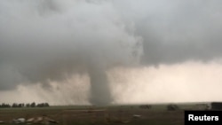 A tornado spins during stormy weather in Mangum, Okla., May 20, 2019. 