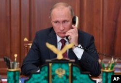 FILE - Russian President Vladimir Putin speaks on the phone with Igor Plotnitsky, the leader of pro-Russian rebels in the Luhansk region, and Alexander Zakharchenko, the leader of pro-Russian rebels in Donetsk region in Moscow, Russia, Nov. 15, 2017.