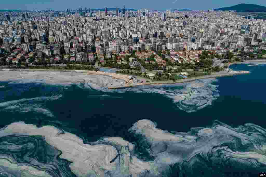 This aerial photograph in Turkey's Marmara Sea at a harbor on the shoreline of Istanbul shows mucilage, a jelly-like layer of slime that develops on the surface of the water due to the excessive proliferation of phytoplankton, gravely threatening the marine biome.
