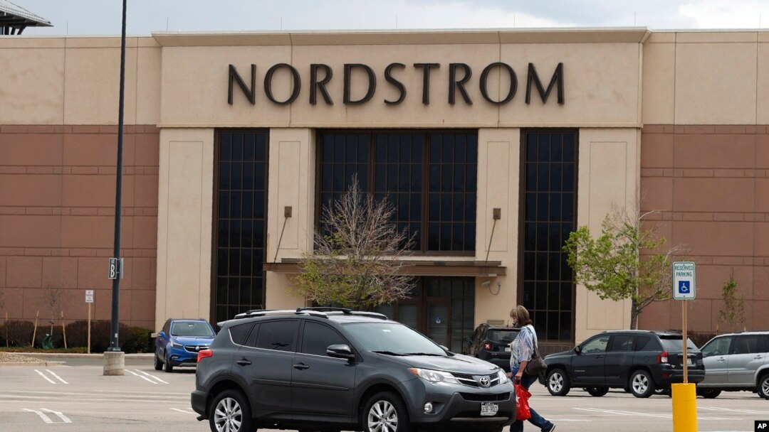 A lone shopper heads back to her vehicle near the Nordstrom department store in the Flatirons Crossing Mall in Broomfield, Colo., May 14, 2020. 