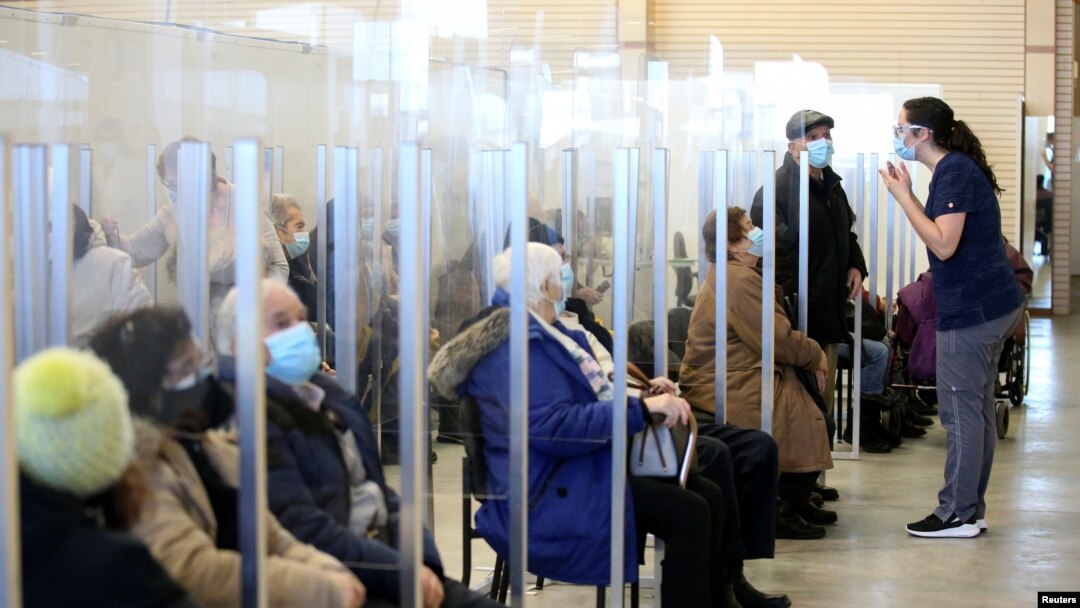 Seniors sit in a waiting room after receiving their vaccine against the coronavirus as Quebec begins vaccinations for seniors over 85 years old in Laval, Quebec, Canada, Feb. 25, 2021.