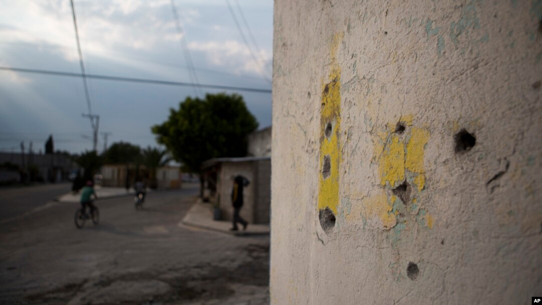 Bullet holes mark a wall at an intersection where a video released by Mexican media outlets appeared to show a soldier executing a civilian lying face down in the street with a shot to the back of his head, in Palmarito Tochapan, Puebla State, May 10, 2017.