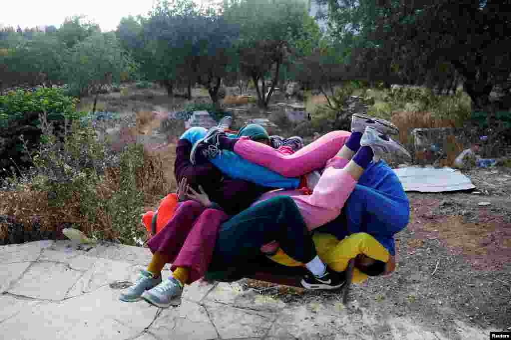 Dancers participate in a "Bodies in Urban Spaces" event choreographed by Austrian artist Willi Dorner as part of the Israel Festival in Jerusalem.