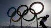 FILE – A skier passes by the Olympic rings at the 2014 Winter Olympics, in Krasnaya Polyana, Russia, Feb. 20, 2014. The International Association of Athletics Federations postponed a final decision over Russia's eligibility for the 2016 Olympics until May.