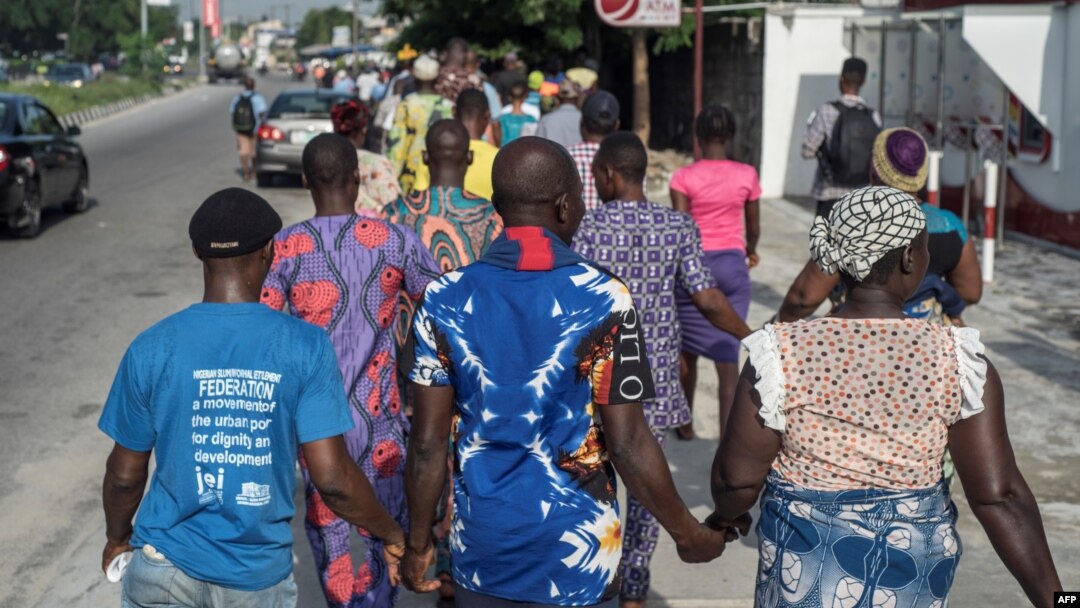 People march in the streets of Lagos as part of the National Day of Mourning, aiming at commemorating all the lives lost to violent killings and mass displacement in the country, on May 28, 2018.