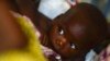 FILE - A child breastfeeds during an information meeting about the prevention of mother-to-child transmission of HIV at the health center in Gatumba, outside Bujumbura, April 19, 2013. 
