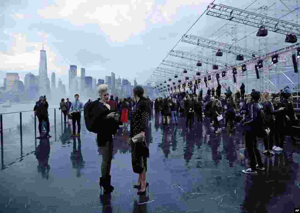 Patrons arrive for Saint Laurent Spring 2019 menswear fashion show Wednesday, June 6, 2018, in Liberty Island, New York.