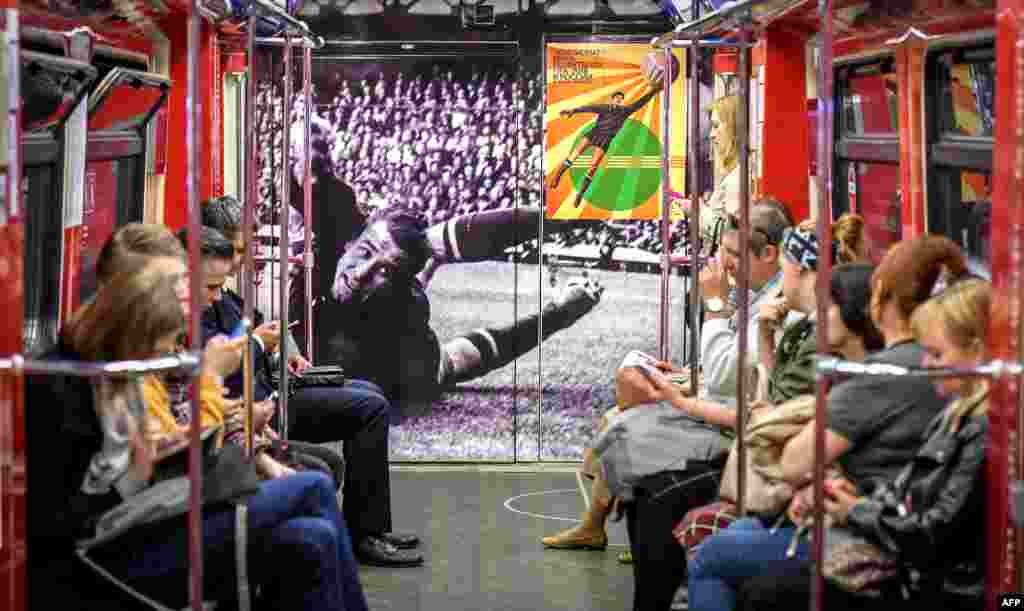 Commuters ride a World Cup themed metro car decorated with a picture of Soviet goalkeeper Lev Yashin in Moscow, ahead of the Russia 2018 World Cup football tournament.