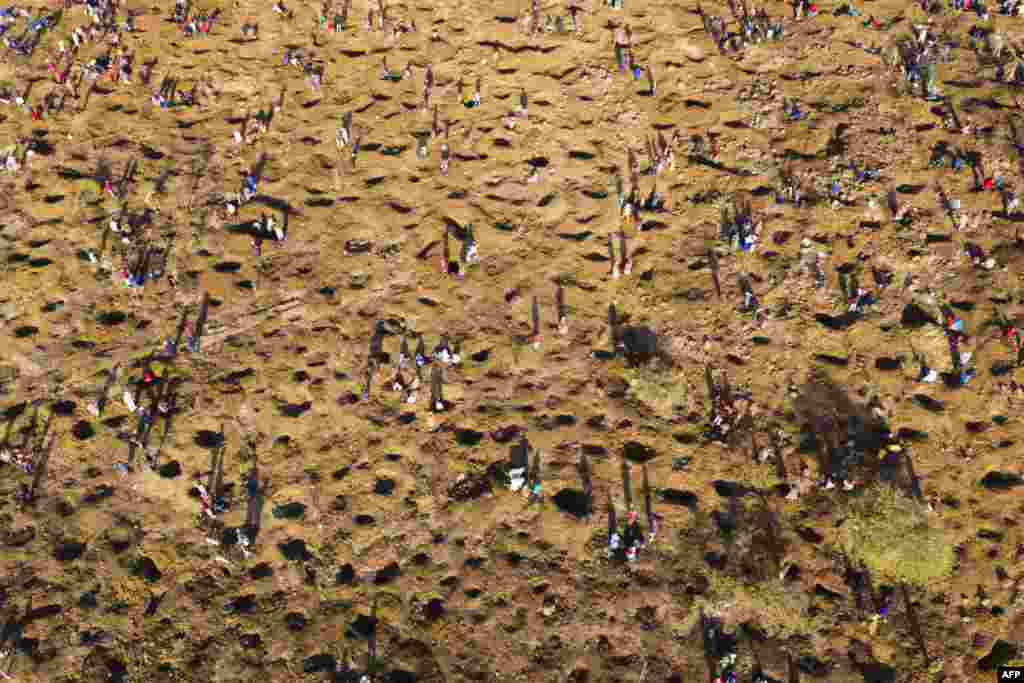 An aerial view shows people digging as they search for what they believe to be diamonds after the discovery of unidentified stones at KwaHlathi village near Ladysmith in KwaZulu Natal, South Africa.