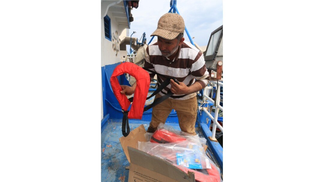 Tunisian fishermen prepare life jackets to be used in case they meet migrants in distress at sea, May 21, 2019, at the port of Zarzis, Tunisia. Most of the fishermen have already brought back migrants, saving hundreds of lives over the years.