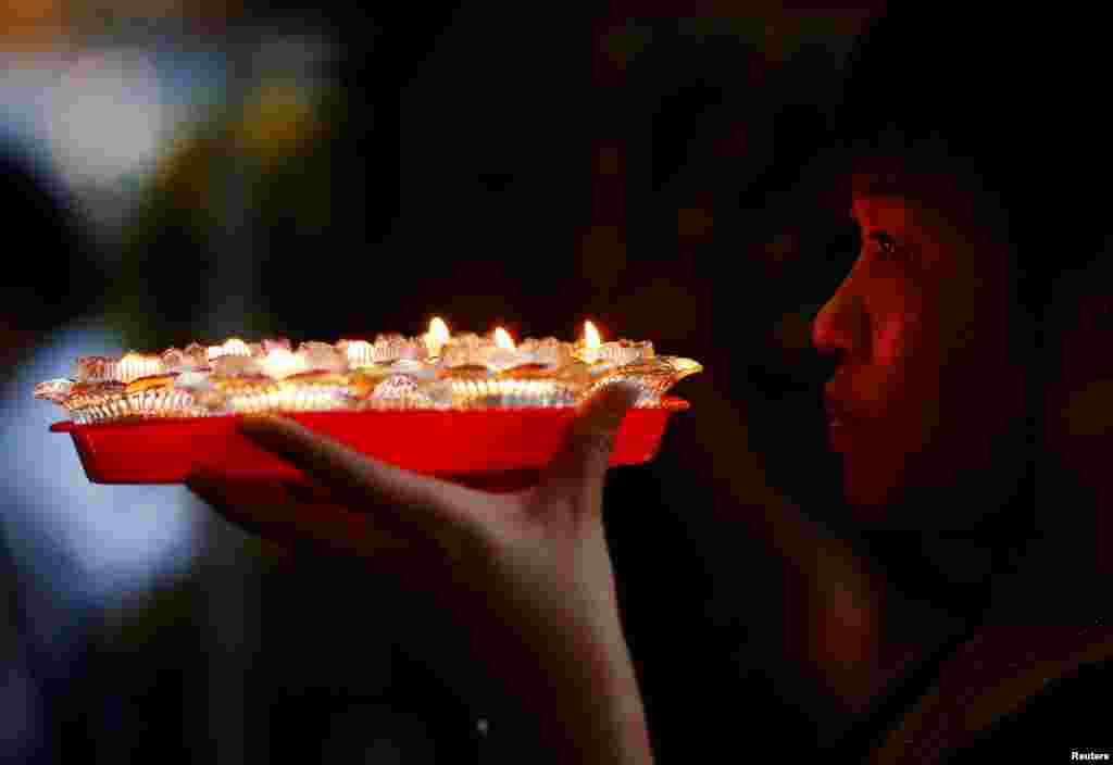 A devotee prays ahead of Vesak Day at Kong Meng San Phor Kark See Monastery in Singapore.