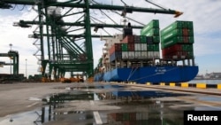 FILE - A ship is unloaded at New Priok Container Terminal One in Tanjung Priok, north Jakarta, Indonesia, Nov. 16, 2016.