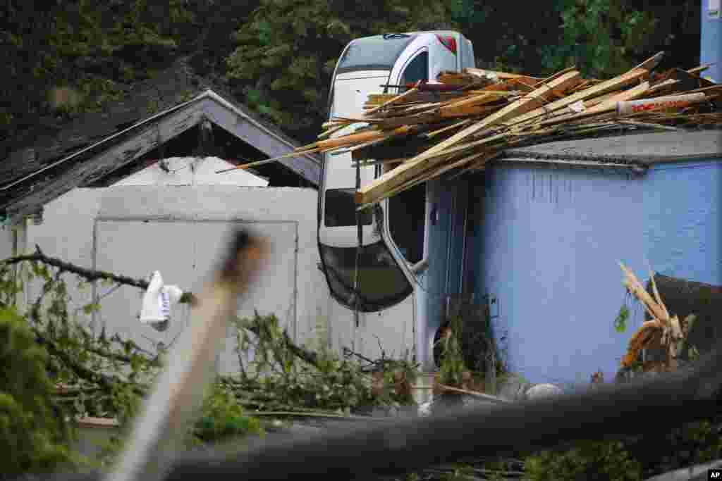 A car is squeezed between houses after the small town was hit by flooding in Simbach am Inn, Germany. Several people have died.