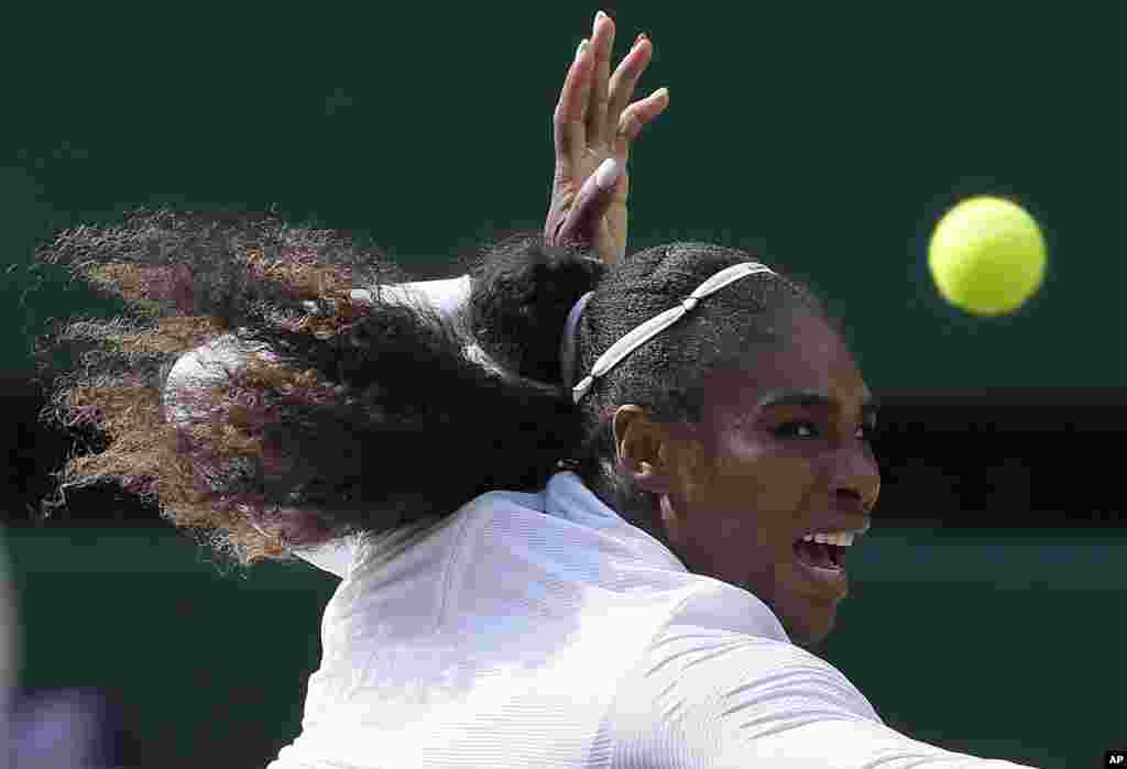 Serena Williams of the United States returns the ball to Germany's Julia Gorges during their women's singles semifinals match at the Wimbledon Tennis Championships in London.