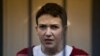FILE - Ukrainian jailed military officer Nadezhda Savchenko listens to the court's decision in a cage at a courtroom in Moscow, Russia, March 4, 2015.