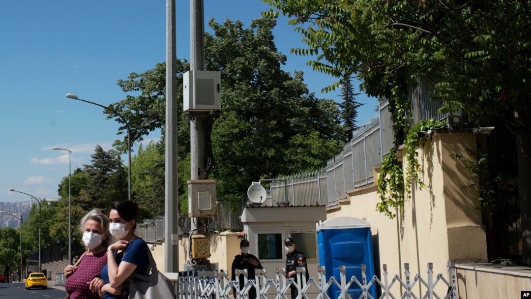 FILE - Turkish police officers stand guard outside the residence of Israeli embassy in Ankara, Turkey, May 21, 2021. 