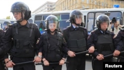 Police officers stand guard during a rally to demand authorities allow opposition candidates to run in the upcoming local election and release protesters, who were detained during recent demonstrations, in Moscow, Russia August 31, 2019. REUTERS…