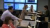 FILE - Workers from the Puerto Rico Health Department and U.S. Centers for Disease Control and Prevention review Zika-related data collected by the island's health department and CDC workers in San Juan, Puerto Rico, Feb. 24, 2016.