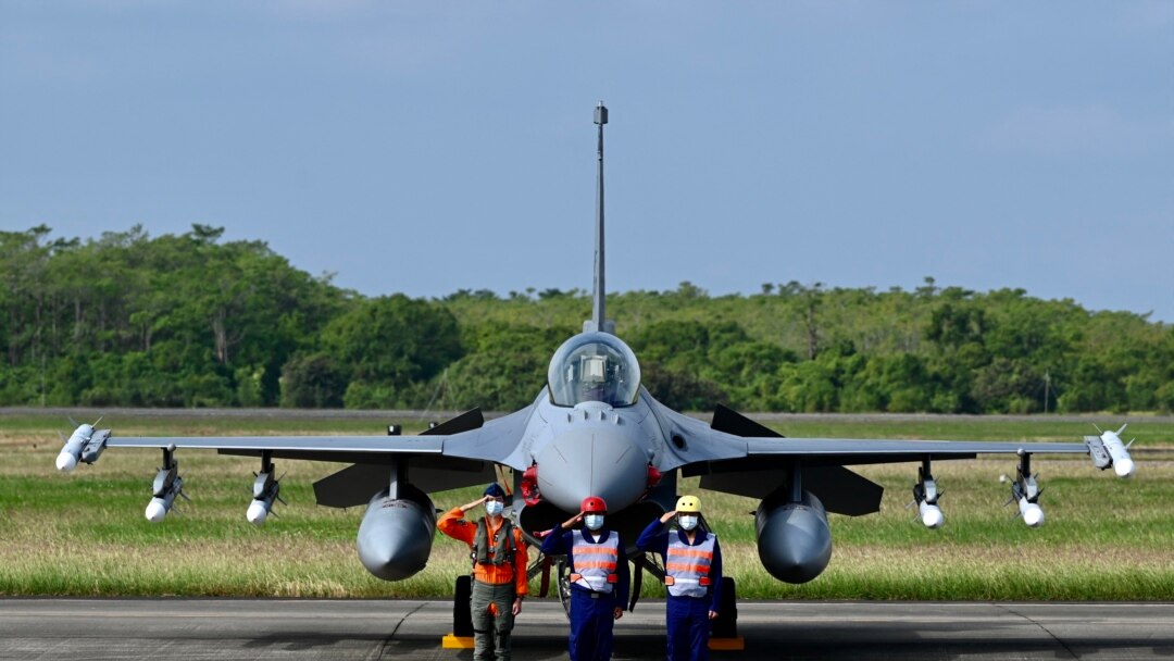 Taiwan Air Force staffers salute in front of an upgraded US-made F-16 V fighter during a ceremony at the Chiayi Air Force in southern Taiwan on Nov. 18, 2021. 