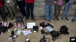 FILE - Members of the press stand by their working tools as they protest violence against journalists, Tijuana, Mexico, August 7, 2010.