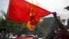 Abner Afuang, a former local mayor and policeman, burns a Chinese flag during a protest over China's imposition of its claims in disputed areas in the South China Sea, in front of the Department of Foreign Affairs headquarters in Manila, Philippines, July