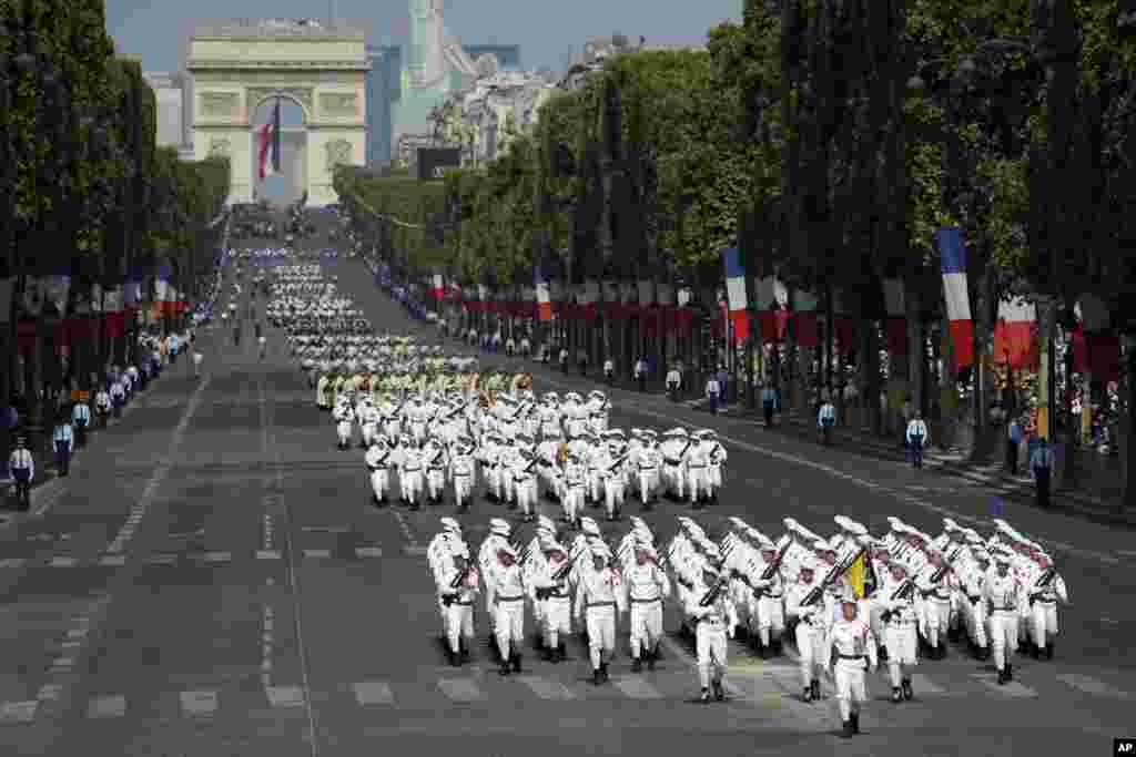French troops march down the Champs Elysee avenue during the Bastille Day parade in Paris, July 14, 2018.