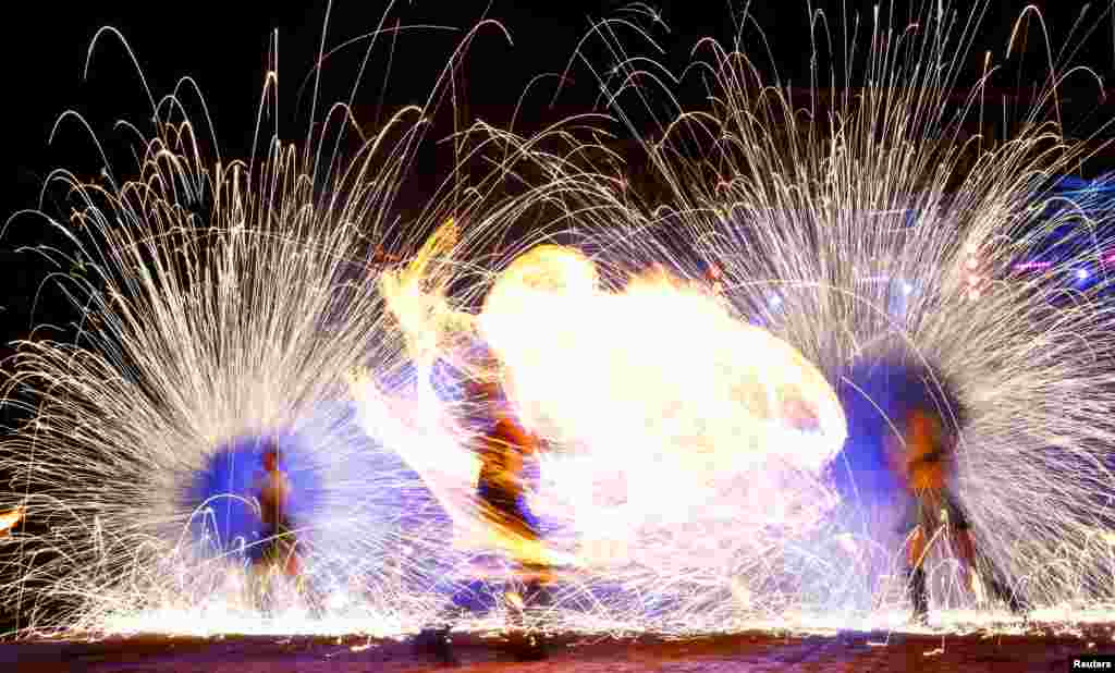 Artists perform during Festival of Fire Theaters at the Museum complex of ancient crafts and technologies Dudutki, Belarus, June 16, 2018.
