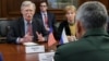 Russia's Defense Minister Sergei Shoigu, back to camera, meets with U.S. national security adviser John Bolton in Moscow, Oct. 23, 2018. 