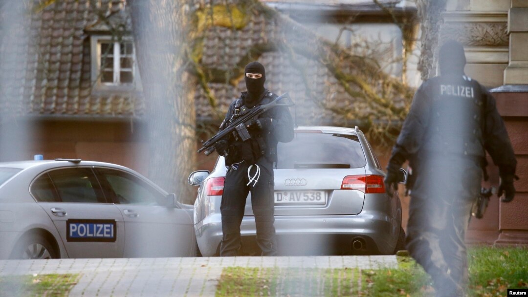 FILE - Members of the German special police force stand guard outside a building in Germany, Dec. 15, 2015.