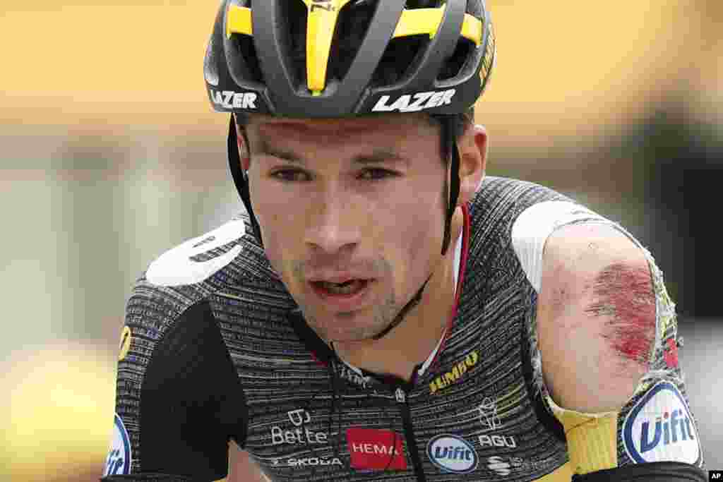 Slovenia's Primoz Roglic crosses the finish line after crashing during the third stage of the Tour de France cycling race over 182.9 kilometers (113.65 miles) with start in Lorient and finish in Pontivy, France.