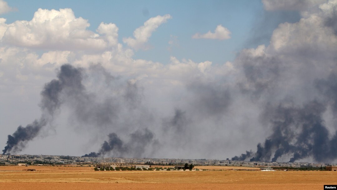 FILE - Smoke rises from Manbij city, Aleppo province, Syria, June 8, 2016. 