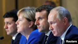 Ukraine's President Volodymyr Zelenskiy, German Chancellor Angela Merkel, French President Emmanuel Macron and Russia's President Vladimir Putin attend a joint news conference after a summit in Paris, Dec. 9, 2019.