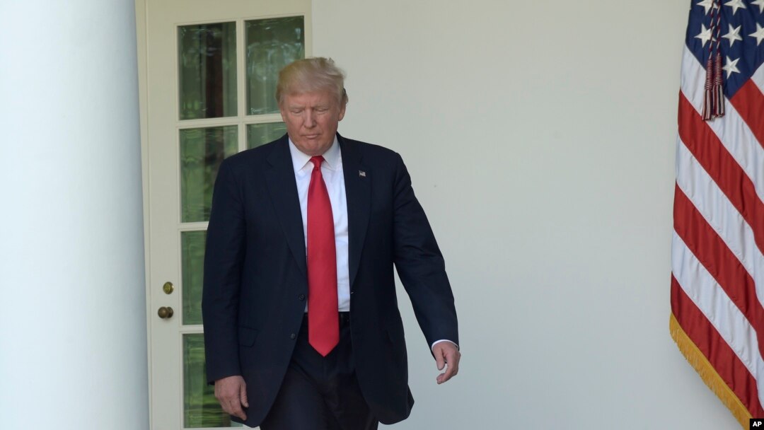 FILE - President Donald Trump walks out of the Oval Office into the Rose Garden of the White House in Washington, June 1, 2017. 