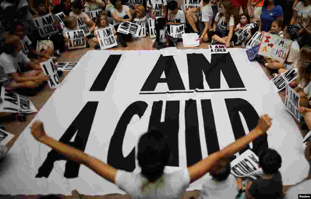 Children and family members take part in a sit-in following a march to mark the court-ordered deadline for the Trump Administration to reunify thousands of families separated at the border, in Washington, U.S.