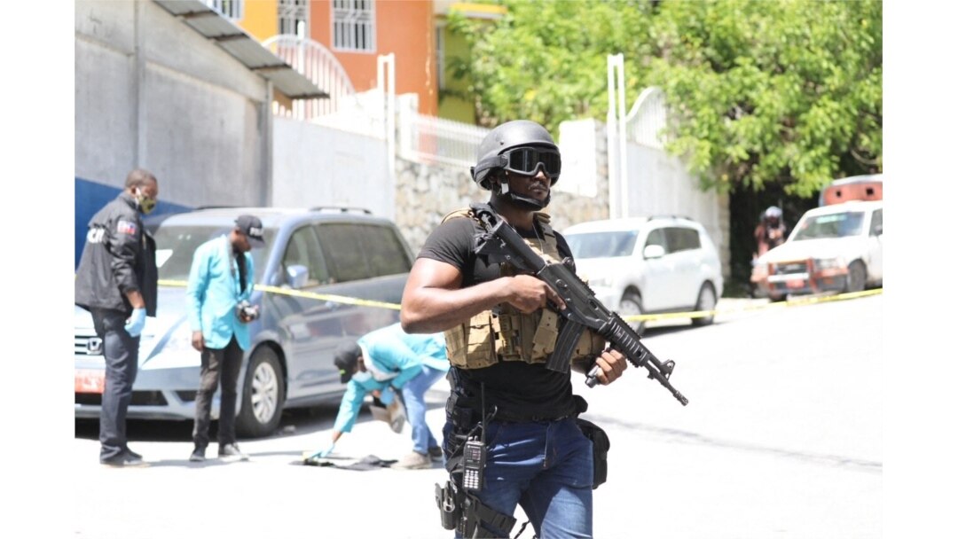 FILE - Members of the Haitian police and forensics look for evidence outside of the presidential residence in Port-au-Prince, Haiti, July 7, 2021.