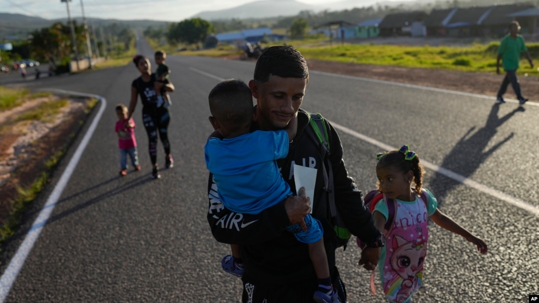 Venezuelan Miguel Gonzalez and his family walk to transportation that will take them to the Brazilian border, in Santa Elena, Venezuela, April 5, 2023.