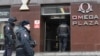 FILE - Russian police officers gather at the entrance to a business center housing the office of opposition leader Alexei Navalny's Anti-Corruption Foundation (FBK), in Moscow, Russia, Jan. 28, 2018.