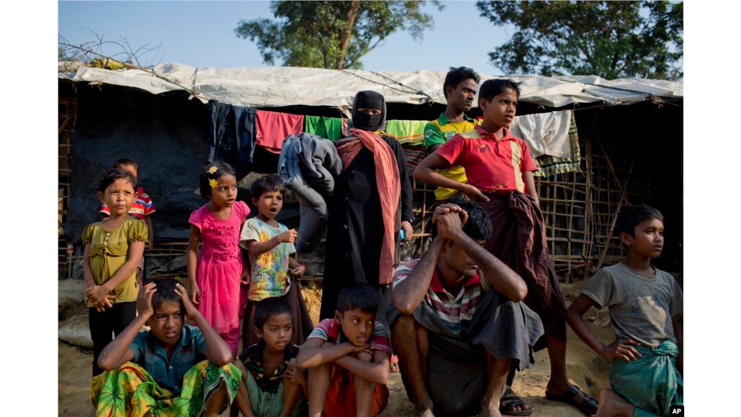 FILE - Rohingya Muslims, who crossed over from Myanmar into Bangladesh, wait to collect aid at Kutupalong refugee camp in Ukhiya, Bangladesh, Dec. 21, 2017.