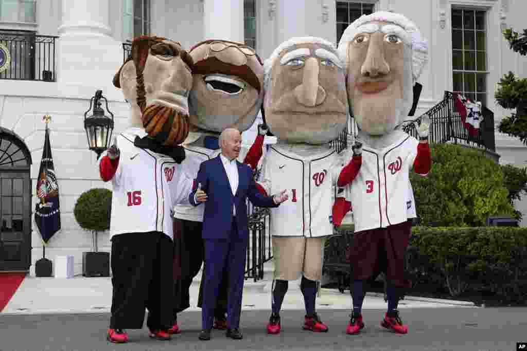 President Joe Biden is seen with members of the Washington Nationals baseball team called "The Racing Presidents" after speaking at an Independence Day celebration on the South Lawn of the White House, July 4, 2021, in Washington.