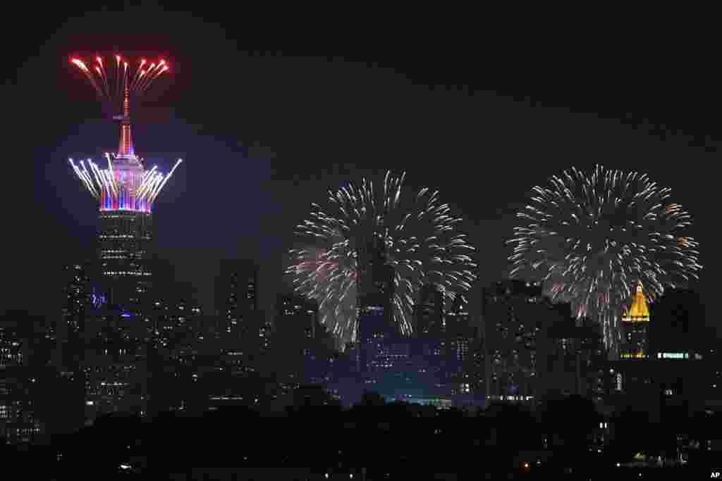 Fireworks explode from the Empire State Building and over the New York City skyline during Macy's 4th of July fireworks display, July 4, 2021, as seen from Jersey City, New Jersey.