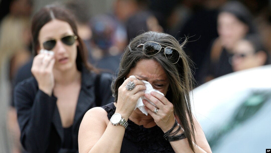 Mourners cry as they leave the funeral service for Anthony Luis Laureano Disla, one of the victims of the Pulse nightclub mass shooting, in Orlando, Florida, June 17, 2016.