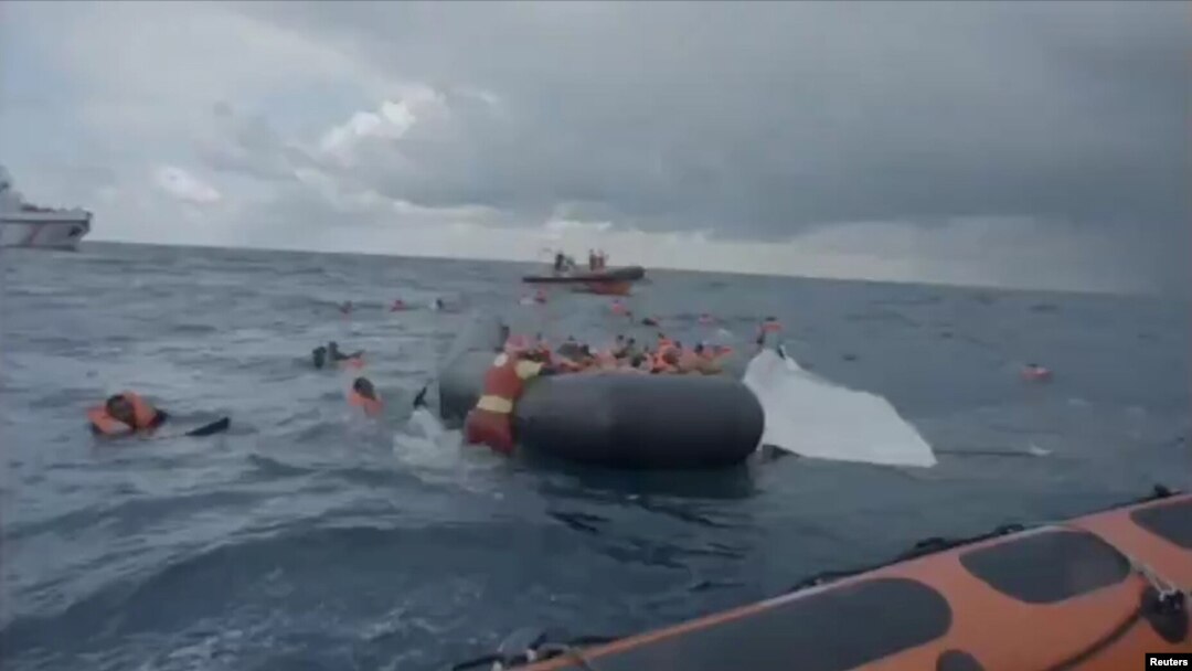 A still image taken from a video shows migrants at sea waiting to be rescued by Spanish search and rescue ship Open Arms during an operation in the Mediterranean Sea, Nov. 11, 2020.